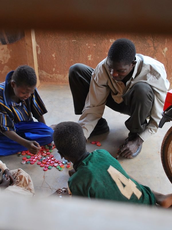 Streetchildren playing a game with capsules in Burkina faso, africa