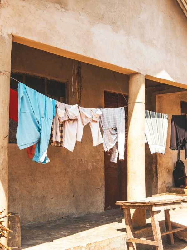 Washed clothes are dried on a rope on the terrace of the house. African village, lifestyle