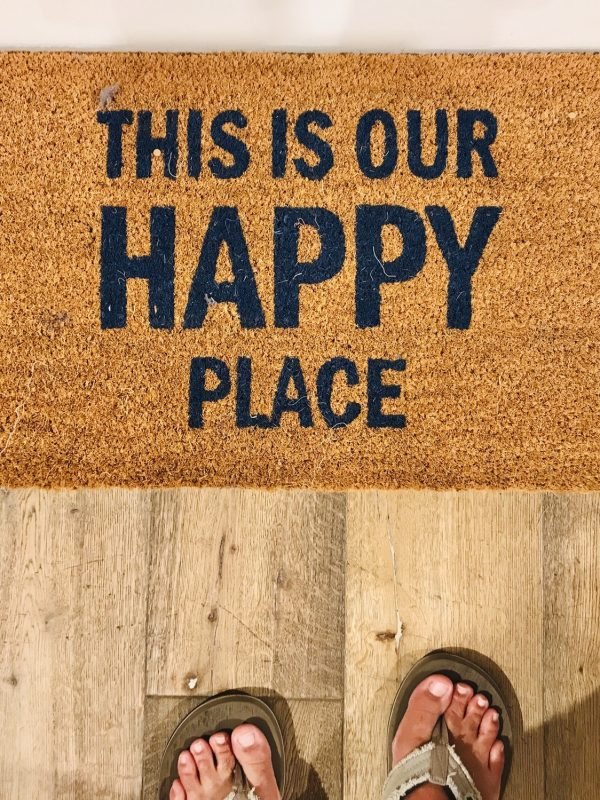 Welcome mat that tells visitors and guests that this home is our happy place